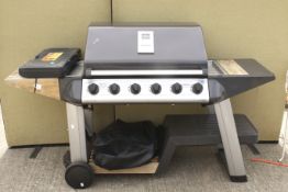 An Outback BBQ and an 18 piece barbecue tool set. On a trolley.