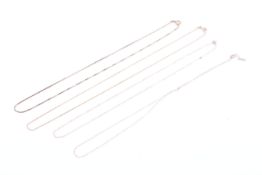 Three 9ct gold fine chains and a box link necklace.