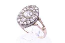 A late Victorian gold and diamond oval cluster ring.