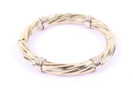 An Italian spiral fluted hollow hinged bangle.