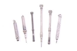 Six Victorian and later silver or white metal cylindrical propelling pencils.