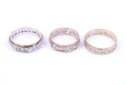 Three vintage 9ct gold and near-colourless paste eternity rings.