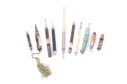 Ten various propelling pencils including a spiral decorated green plastic example.
