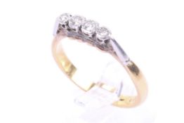 A 22ct gold and diamond four stone ring. Worn 22ct hallmark to inside of band.