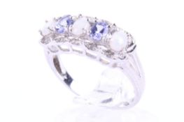 A modern 9ct white gold, opal, tanzanite five stone ring with tiny diamond points.