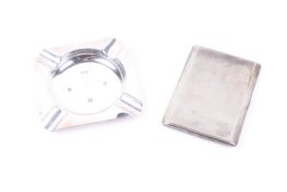 A silver cigarette case and square ash tray.