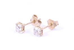 A pair of diamond single stone stud earrings. Each with a round brilliant diamond approx. 0.