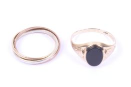 A vintage 9ct tri-colour gold 'Russian' wedding band and a black onyx signet ring.