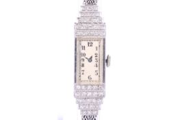 A vintage lady's platinum and diamond wrist watch on a 9ct white gold bracelet, circa 1961.