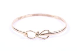 A vintage 9ct gold 'lovers knot' bangle.