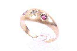 An Edwardian 18ct gold red stone and diamond three stone gypsy ring. Birmingham 1906, size T, 2.