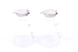 A pair of Edward VII clear glass and silver mounted whisky noggins.
