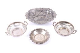A pair of silver pierced round sweet dishes and two others.