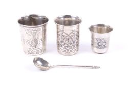Three 19th century Russian silver and niello beakers and a spoon.