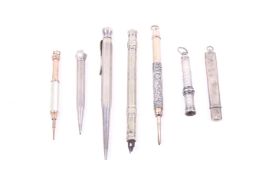 A group of seven early 20th century white and/or gilt metal propelling pencils.