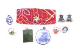 A small collection of Oriental jewellery including two gilt-metal mounted nephrite jade buddha