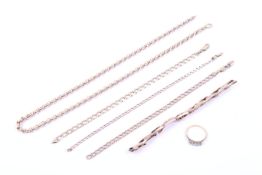 A collection of gold jewellery including a small diamond ring.