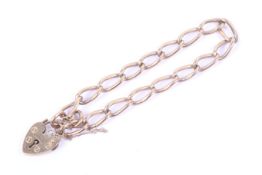 A vintage 9ct gold curb link bracelet. On a padlock clasp with hallmarks for London 1979, approx.