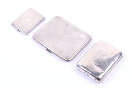 Two silver cigarette cases and a silver match book cover.