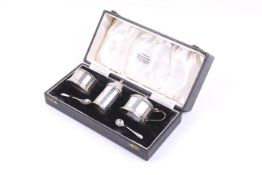 An Art Deco silver faceted-cylindrical three piece cruet set.