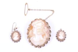 A vintage 9ct gold and oval shell cameo brooch and a pair of similar pendent earrings.