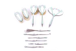 A George V silver and enamel mounted piece dressing table set.