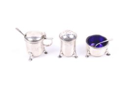 A E Jones, a silver three piece cruet set.
