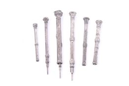 A group of six Victorian and later white metal propelling pencils.