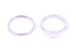 A modern platinum and baguette diamond solitaire ring and a wedding band.