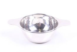Liberty & Co Ltd. a planished-silver round bowl with two flat handles.