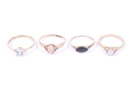 Four 9ct gold and gem set single stone rings.