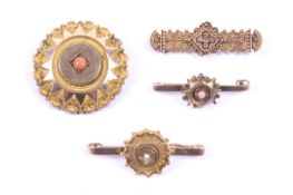 Four Victorian gold and gem set brooches including a bar brooch decorated with bead and wirework in