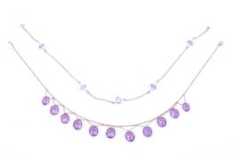 Two gold and 'gem' necklaces.