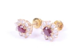 A pair of vintage ruby and diamond oval cluster stud earrings.