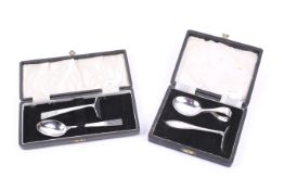 Two silver christening spoon and pusher sets.