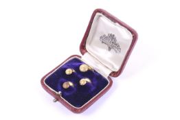 A set of four early 20th century gold round studs.