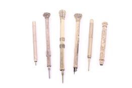A group of seven Victorian and later gilt metal propelling pencils.