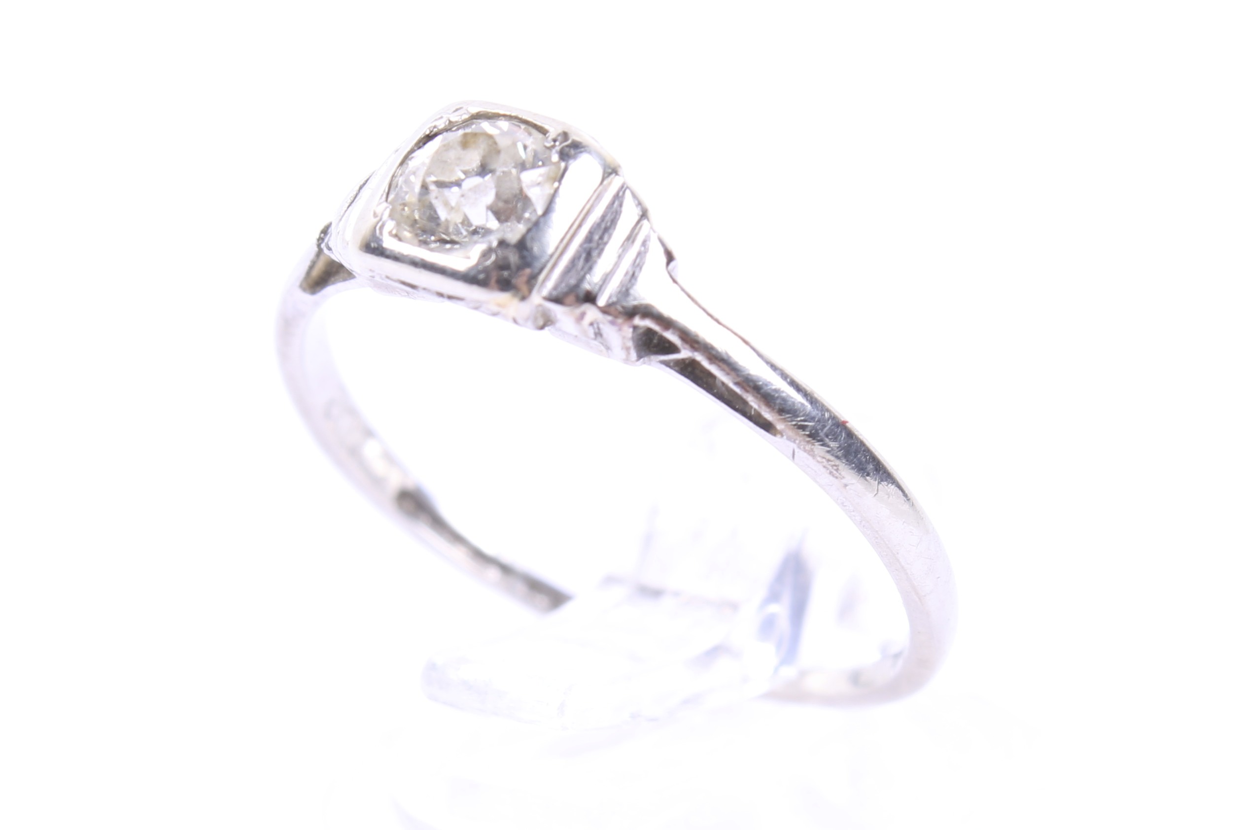 A mid-20th century gold and diamond solitaire eing. The old-cut diamond approx. 0.