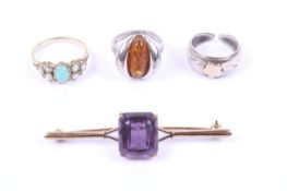 A small collection of jewellery including a turquoise and half-pearl dress ring. A Baltic amber .