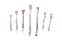 A group of seven Victorian and later smaller white metal propelling pencils.