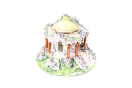 A early 19th century Coalport posy pot. In the form of woodland cottage, H10.