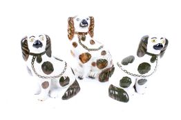 A pair of late 19th century Staffordshire pottery dogs and another. Max.