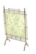 An Aesthetic movement brass fire screen in the style of Christopher Dresser.