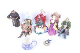 Nine porcelain figures and a jug.