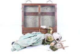 An Indonesian string puppet and a Chinese display case.
