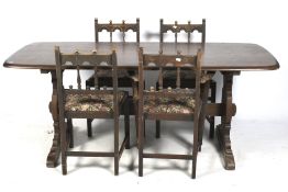 A mid-century ercol table and a set of four carved chairs.