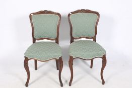 A pair of rosewood chairs.