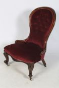 An Edwardian re-upholstered button back nursing chair.