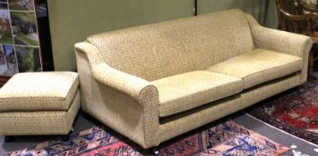 A re-upholstered 20th century three seater sofa and a matching footstool.