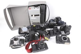 A Leica 35mm slide projector and a box of SLR film cameras. Including Canon, Nikon and Pentax, etc.